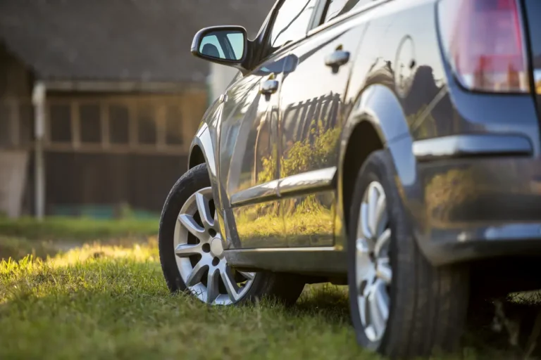 new shiny gray car parked on green grass on blurre 2023 11 27 05 29 00 utc